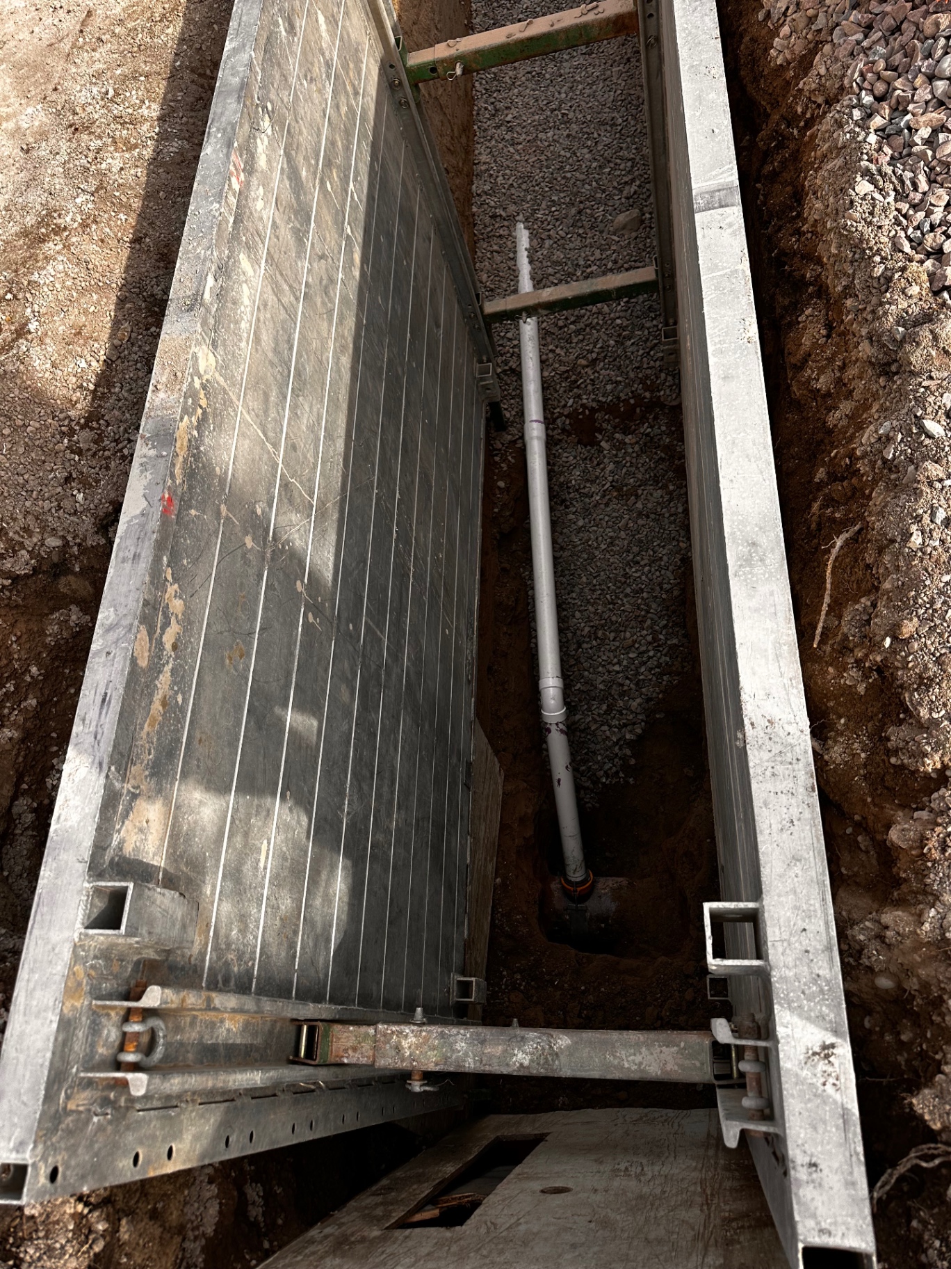 Shored trench with sewer line tie-in